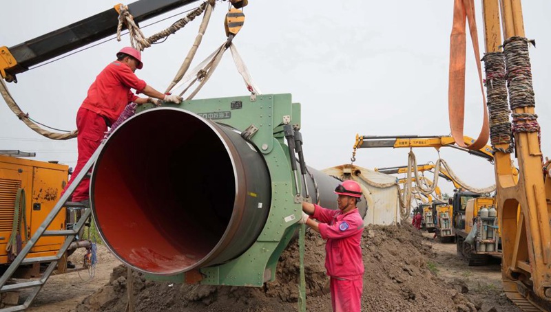 Arbeiter installieren Rohrabschnitt für Erdgasleitung in Nordchina