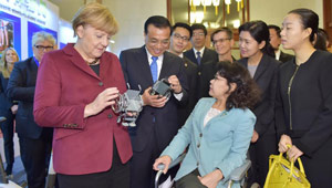 Li Keqiang und Angela Merkel besuchen eine Austellung
