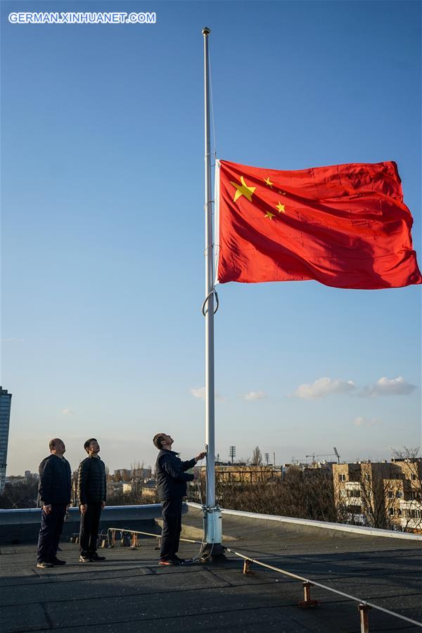 poland-warsaw-covid-19-chinese embassy-national flag-half-mast